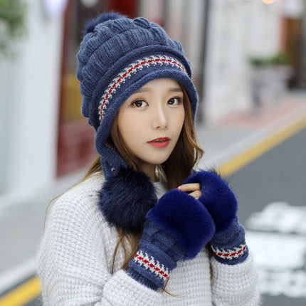 Woman in a knitted bobble hat with ear flaps