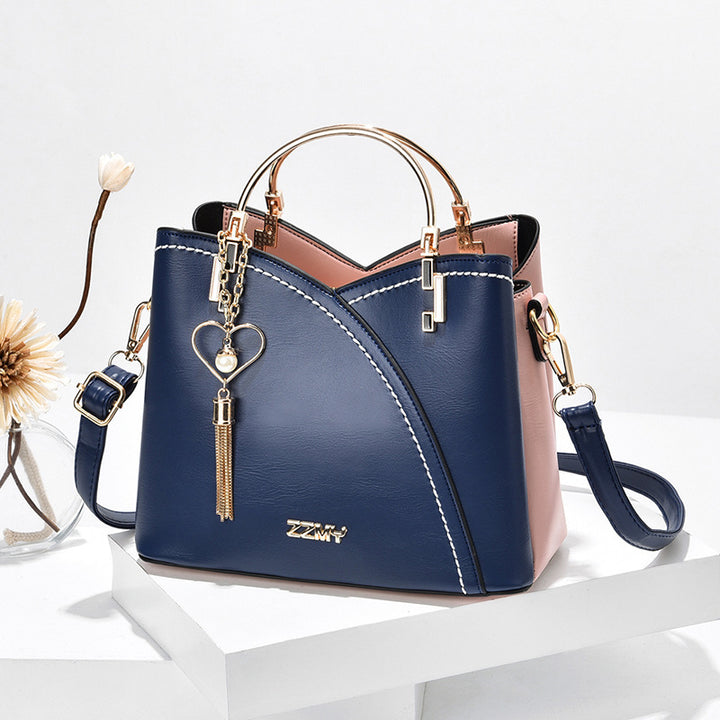 Colour block handbag with heart tassel